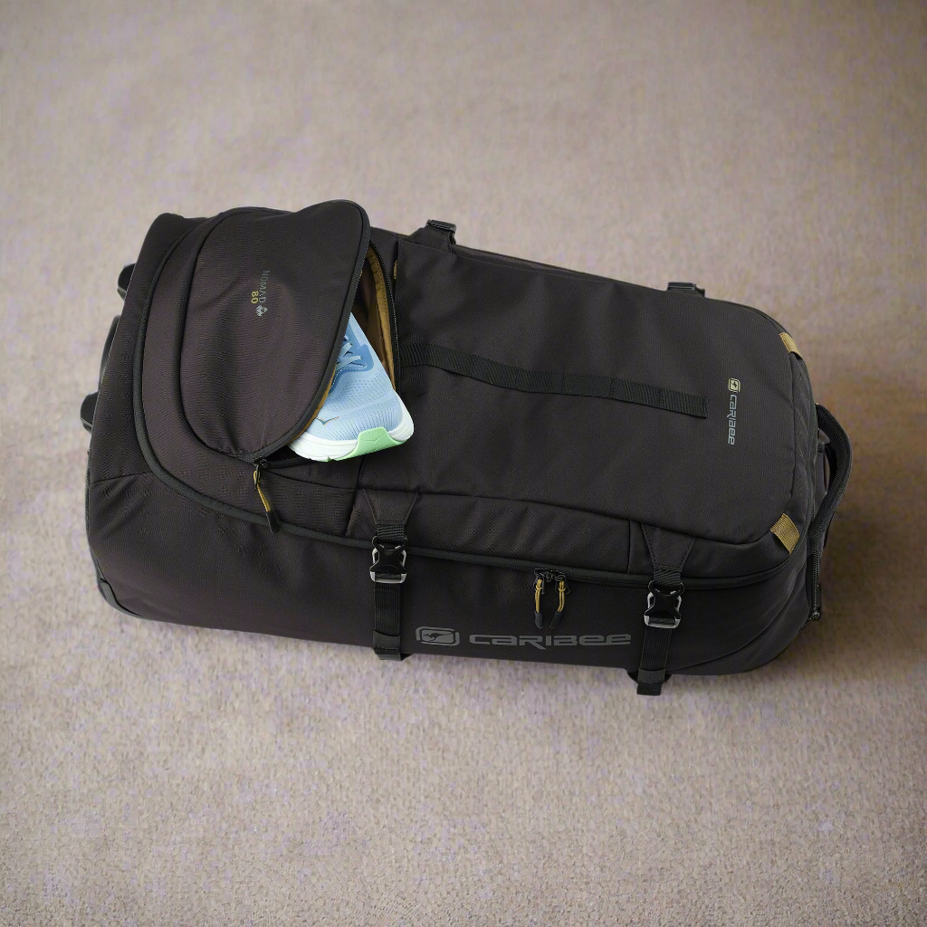 Black suitcase with open top compartment on a beige carpet