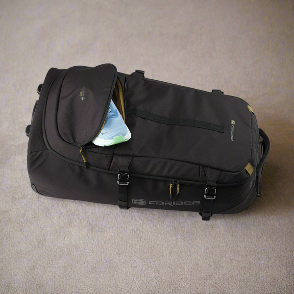 Black suitcase with open top compartment on a beige carpet