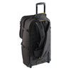 Black rolling suitcase with open compartment on a white background with backpack harness showing