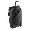 Black rolling suitcase on a white background with backpack harness showing
