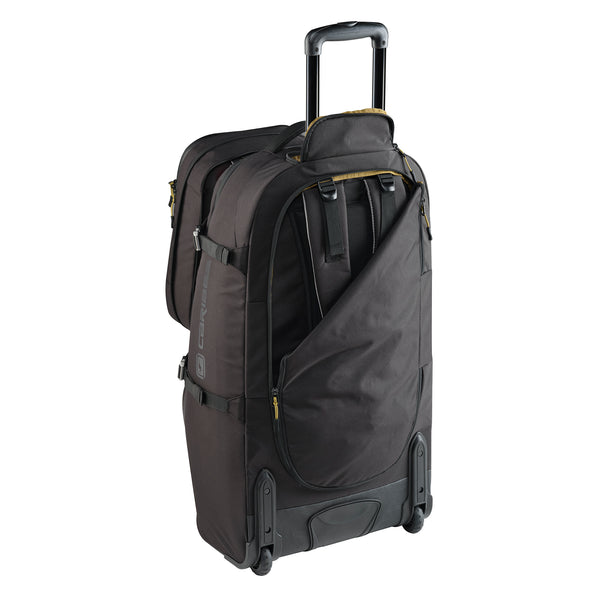 Black rolling suitcase on a white background with backpack harness showing