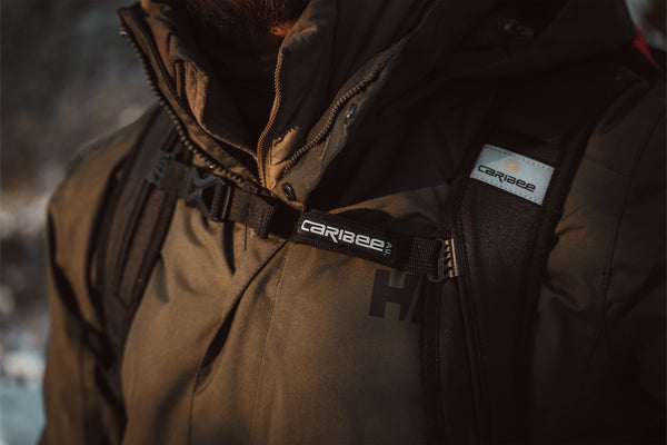Brown jacket with Caribee logo on a blurred background